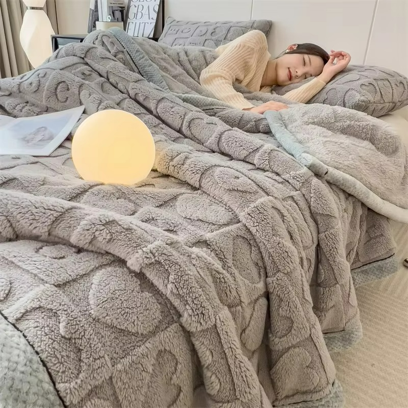 Person lying on a bed with a textured gray blanket, holding a round light.