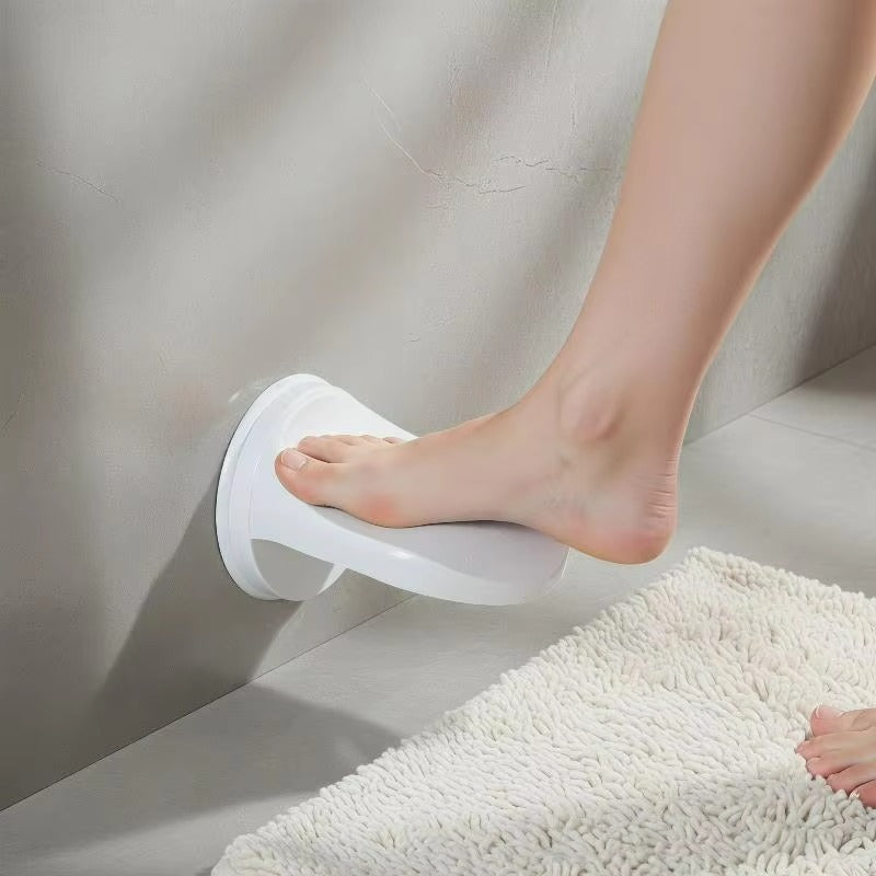 Person using a white suction cup step stool on a textured floor.