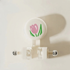 Retractable badge holder with a pink tulip design on a white background