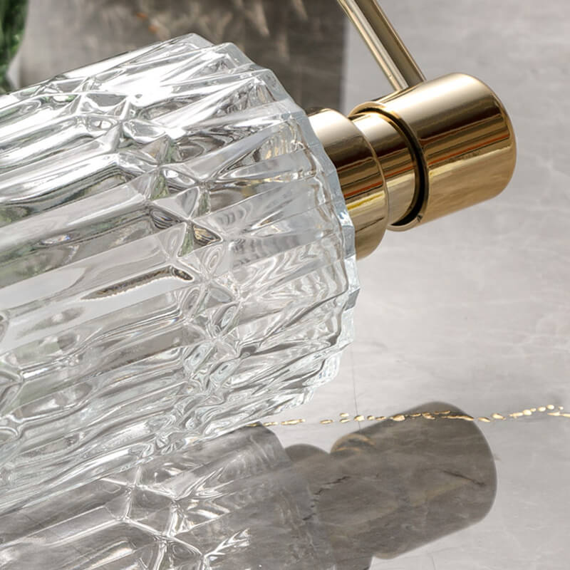 Close-up of a crystal faucet handle with gold finish