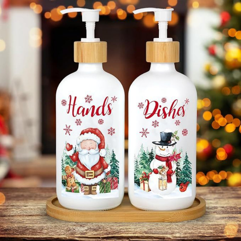 Two Christmas-themed soap bottles on a wooden surface with a blurred festive background.
