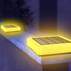 Solar-powered LED lights emitting a warm glow on a surface.