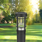 Black solar lamp post in a park with green grass and trees