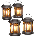 Four solar-powered lanterns with a warm glow on a white background