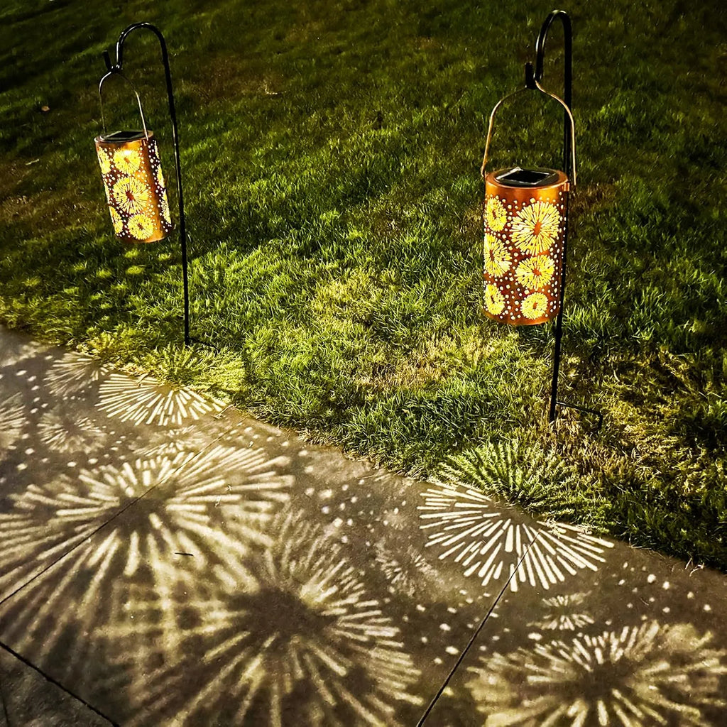 Solar-powered garden lanterns casting decorative shadows on a pavement.