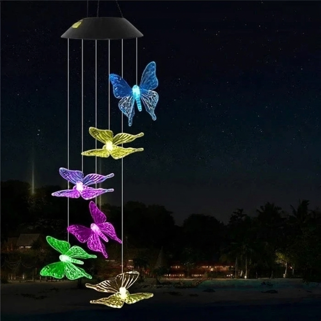 Colorful butterfly-shaped LED wind chime against a dark night sky.