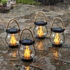 Solar-powered lanterns with flame effect on a stone surface