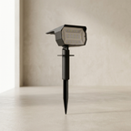 Black outdoor solar lamp on a beige background