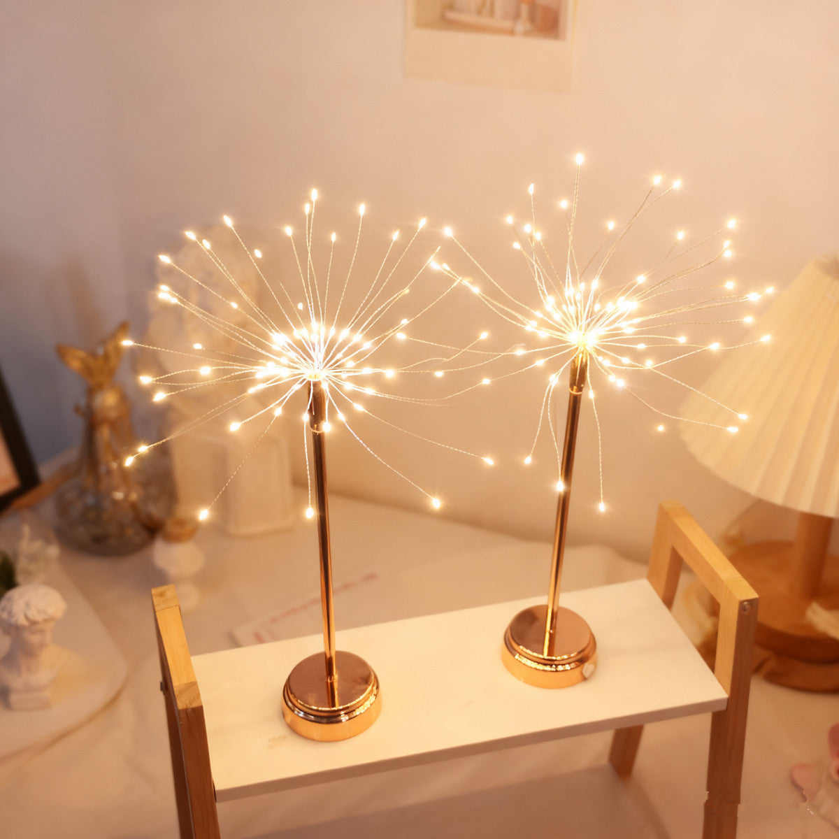 Two decorative sparkler lights on a table in a room setting.