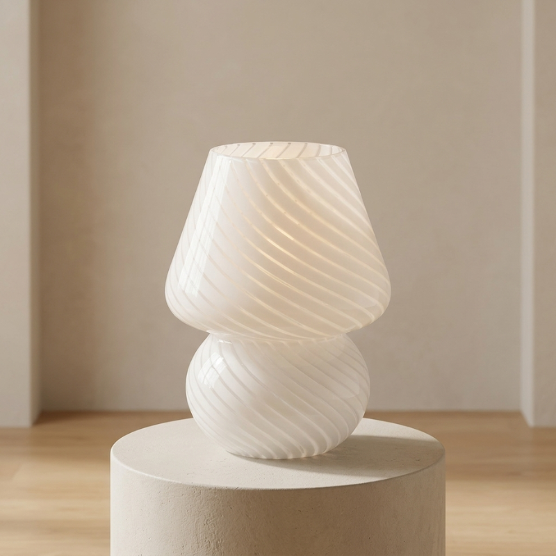 White textured table lamp on a round pedestal against a neutral background