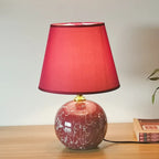 Table lamp with a red shade on a wooden surface