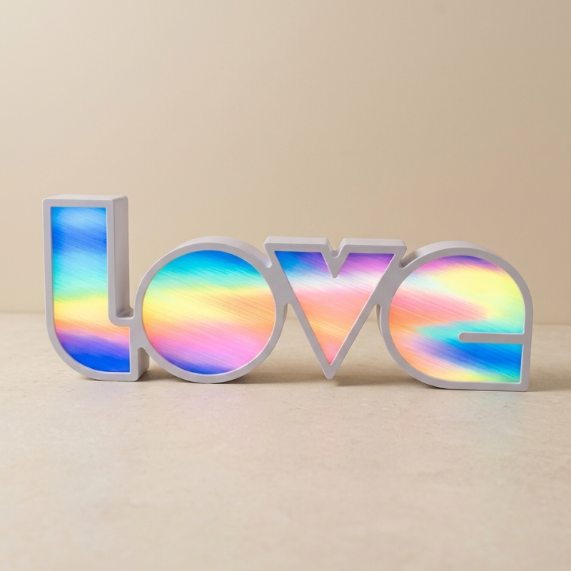 Colorful 'LOVE' sign on a beige background