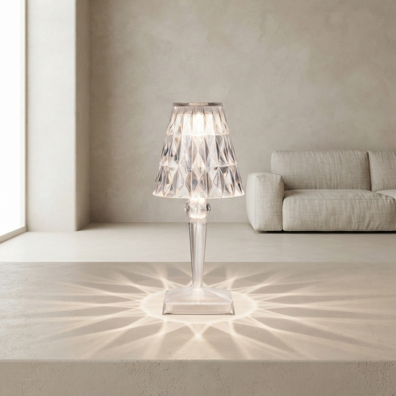 Modern table lamp with a clear glass shade in a minimalistic room.