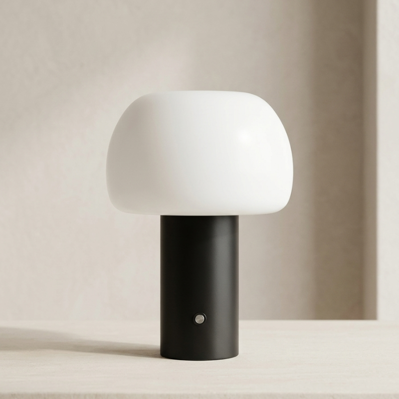 Table lamp with white shade and black base on a neutral background