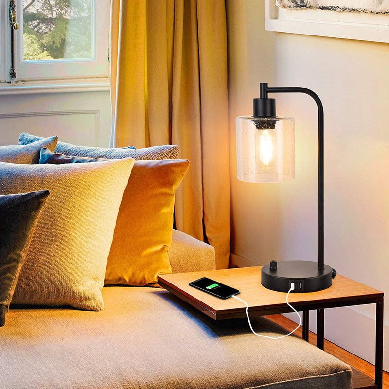 Modern living room with a sofa, lamp, and smartphone on a side table.