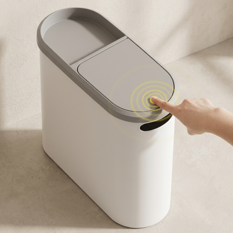 Smart trash can with a hand pressing the lid, set against a neutral background.
