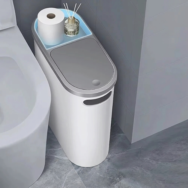 Bathroom trash can with a small shelf holding toilet paper and a candle.