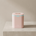 Pink electronic device with a blue light on a beige surface and background