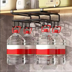 A black metal kitchen water jug rack hanging under a shelf, holding four large clear plastic water bottles with red-and-white labels.