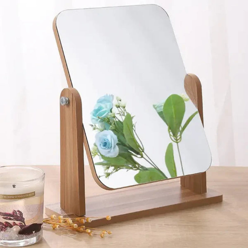 Wooden vanity mirror with floral reflection on a wooden surface