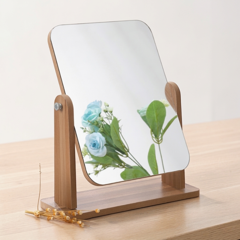 Wooden-framed mirror with floral reflection on a wooden surface