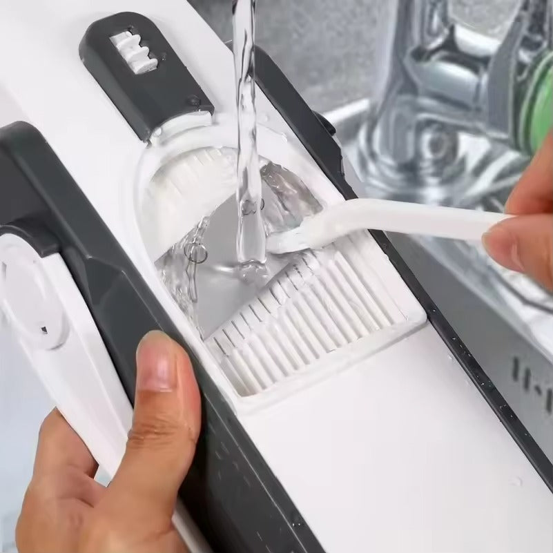 Person using a kitchen tool to clean a sink with water