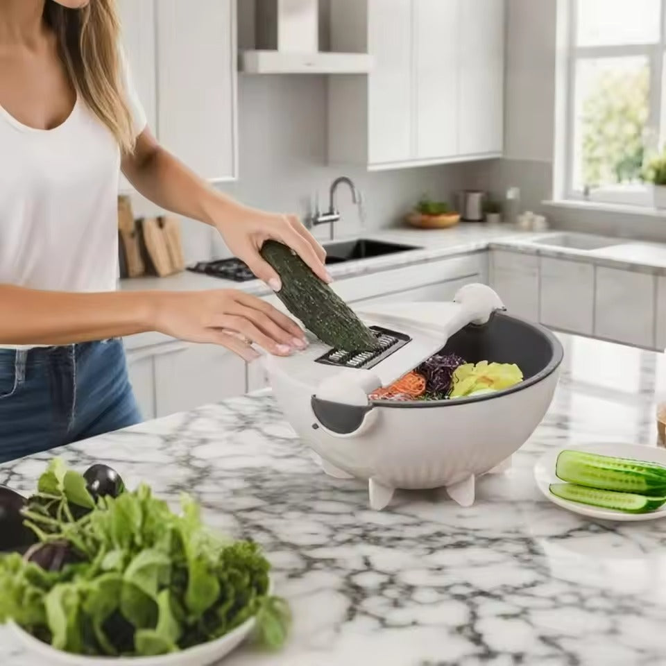 Person using a kitchen tool to slice cucumbers on a marble countertop.