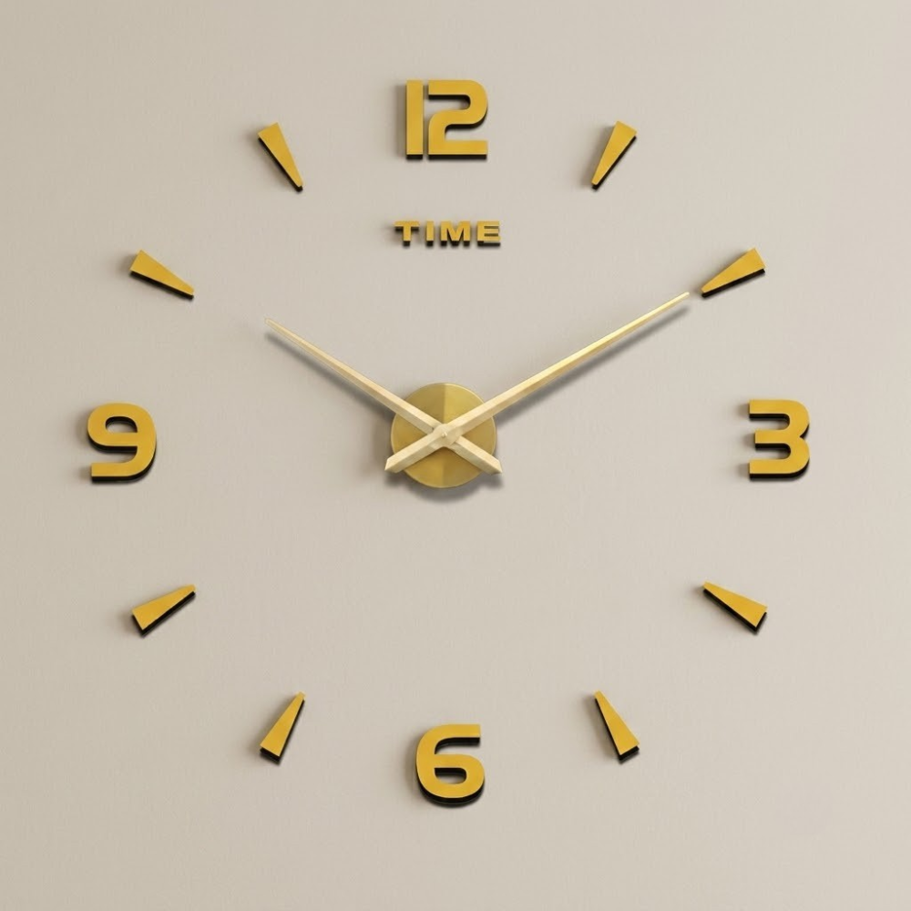 Gold wall clock with large numbers on a beige background