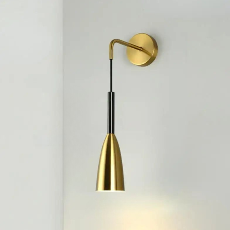Gold wall-mounted lamp on a light gray background