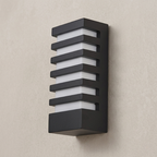 Modern outdoor wall light fixture on a beige wall