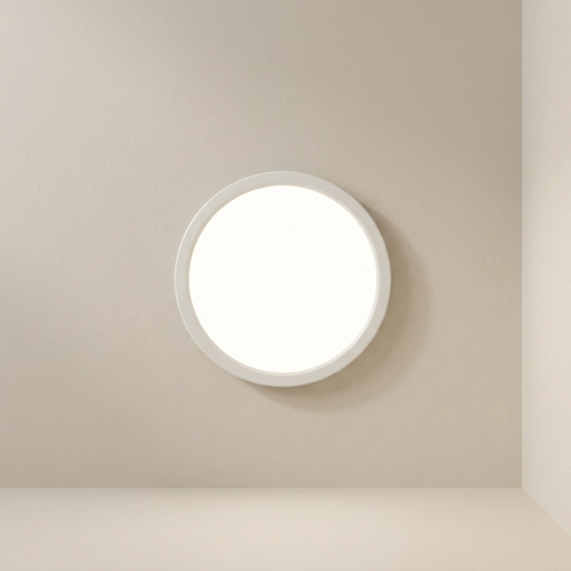 Round ceiling light fixture on a beige wall