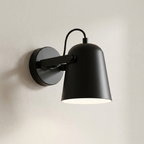 Black wall-mounted lamp on a neutral background