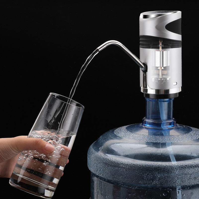 Hand pouring water from a blue water dispenser into a glass against a black background