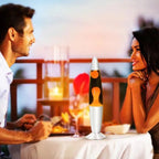 Couple at a romantic dinner with a lava lamp on the table.
