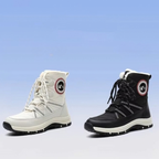 Two mid-calf lace-up winter boots shown side by side on a light blue gradient background. The left boot is off-white/cream with black and red detailing, and the right boot is black with white and red detailing.