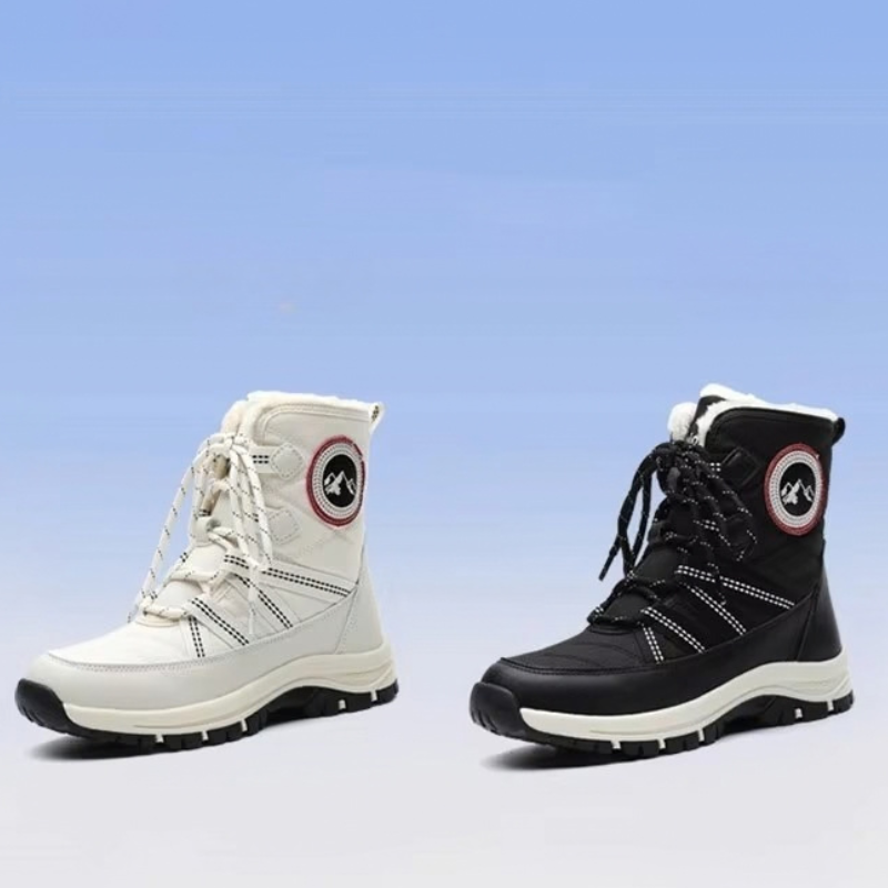 Two mid-calf lace-up winter boots shown side by side on a light blue gradient background. The left boot is off-white/cream with black and red detailing, and the right boot is black with white and red detailing.