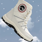 A white mid-calf winter boot with black and red accents, shown floating against a blue sky with clouds and snowflake graphics. The boot features a circular logo patch on the side and a black treaded sole.