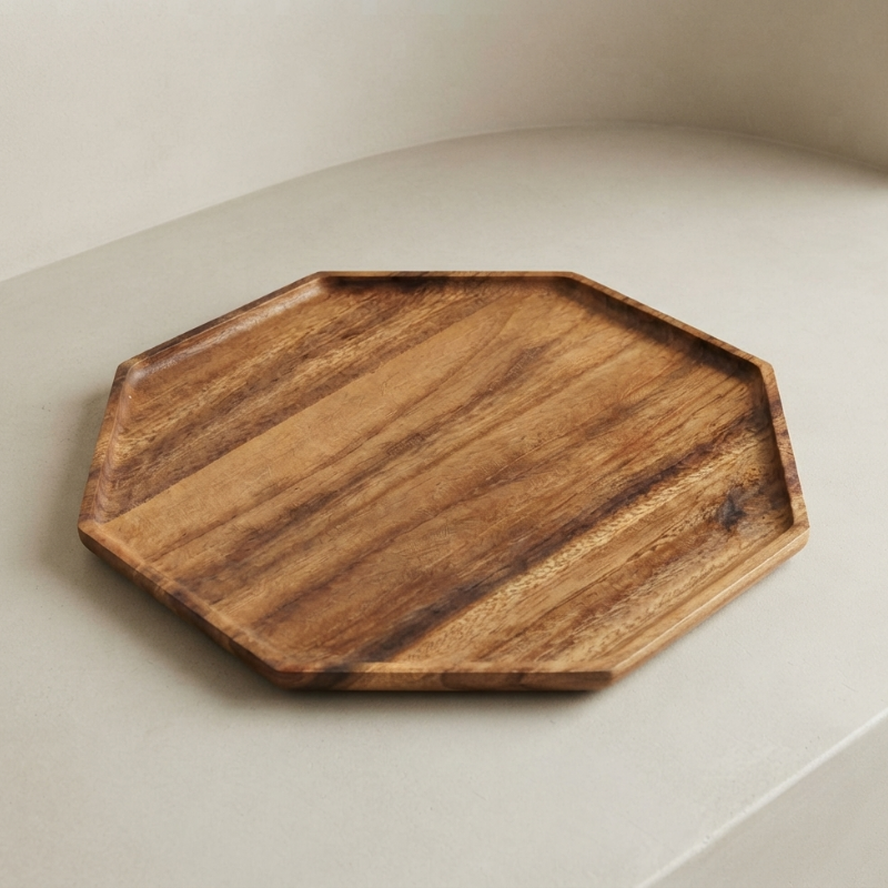 An octagonal wooden serving tray with a natural wood grain pattern, resting on a light beige surface.
