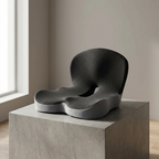 Modern black chair on a concrete platform with a neutral background