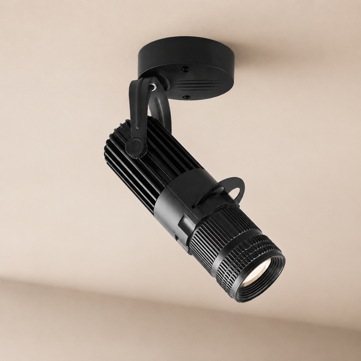 Black spotlight on a beige ceiling