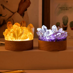 Two crystal-themed night lights, one glowing yellow and the other purple, on a neutral background.