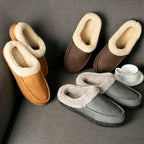 Pair of brown and gray slippers on a gray surface with a cup and saucer.