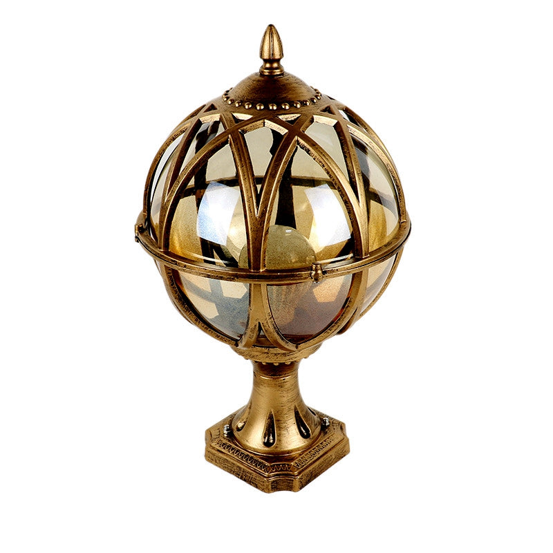 Decorative gold lantern with glass sphere on a white background