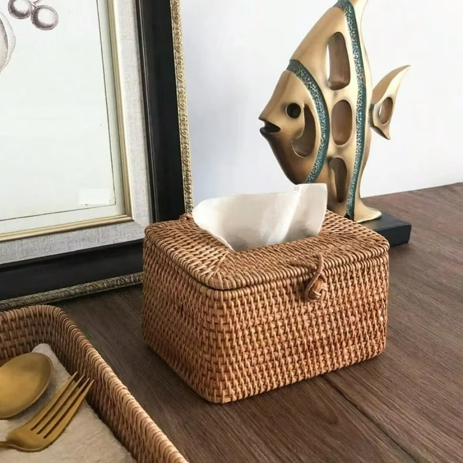 Woven tissue box on a wooden surface with decorative elements