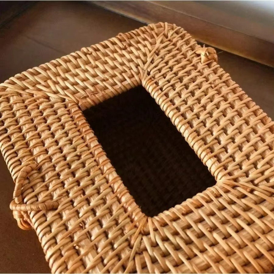 Woven rattan mat with a rectangular hole on a wooden floor.
