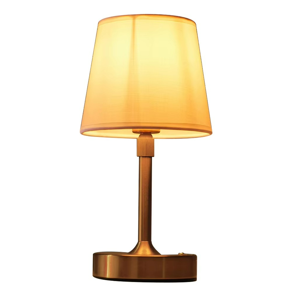 Table lamp with a yellow shade and bronze base on a white background