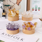 Four crystal containers on a surface with a magazine underneath