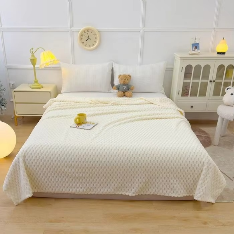 Bedroom with a bed covered by a white quilt, nightstands, and a teddy bear.