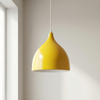 Yellow pendant light hanging in a room with a neutral color scheme