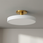 Ceiling light fixture with white shade and gold finish on a neutral background
